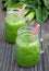 Green smoothie with celery, cucumber, spinach, apple and lemon