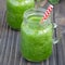 Green smoothie with celery, cucumber, spinach, apple and lemon, square