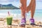 Green smoothie fitness woman tying running shoes