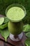 Green smoothie made with spinach and kiwi outdoor