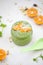 Green smothie with mandarine and granola.