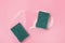 Green Soapy Sponge with Foam on Pink Background Horizontal Top View Housekeeping Concept