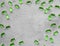 Green soft gelatin transparent capsules laid out on a gray concrete background with copy space . The concept of pharmacology,