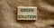 Green solution symbol. Wooden blocks form the words `green solution` on beautiful canvas background. Business, ecological and