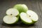 Green sour apple on wood table sliced