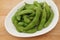 Green soybeans edamame japanese snack on plate on table