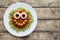 Green spaghetti pasta creative halloween food monster with cute smile and big mozzarella eyeballs