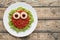 Green spaghetti pasta creative halloween food monster with fake blood tomato sauce