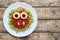 Green spaghetti pasta creative halloween food vampire monster with fake blood tomato sauce and big mozzarella eyeballs