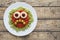 Green spaghetti pasta creative spooky halloween food monster with sad smile