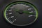 Green speedometer in car on dashboard