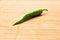 Green spicy pepper on bamboo board