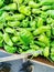 Green spicy peppers in a random pile at a local farmers market