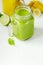 Green Spinach Avocado Smoothie and Banana Mango Smoothie in mason jars