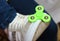 Green spinner on the foot shod in sneakers