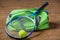 Green sports bag and a racket for a game of tennis close-up on t