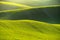 Green spring nature background with setting sun and grass. Waves on the field.  Moravian Tuscany - Czech Republic - Europe