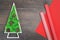 Green stabilized Christmas tree and red gift wrapping paper