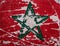 Green star on flag of Morocco on street wall background