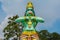 Green statue of God Hanuman tearing his chest