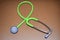 Green Stethoscope Brown Background