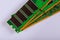 Green stick of RAM memory for computer with electronics components on computer repair space for your text