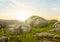 Green stony field at the sunset