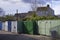 Green storage containers next to council house estate