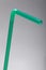 Green straw on grey background with a shallow DOF