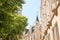 Green street in a European city with beautiful facades of houses