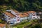 Green street, white houses, red roofs. Sunny day. Cudillero, Asturias, Spain