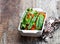 Green string beans and carrot with spices on wooden table