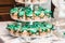 Green style wedding candy bar on a white table. cupcakes decorated with a green ribbon bow