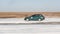 Green subaru Impreza on ice track