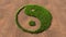 Green summer lawn grass symbol shape on brown soil or earth background, chinese symbol of Yin-Yang