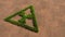 Green summer lawn grass symbol shape on brown soil or earth background, nuclear danger icon