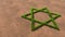 Green summer lawn grass symbol shape on brown soil or earth background, sign of religious hebrew David star