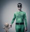 Green superhero holding a teddy bear