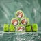 Green Sushi roll pyramid. Inside out roll with red fish on green blurred background. Asian or Japanese food, Oriental