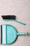 Green sweeping brush and dustpan on floor - housework