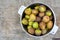 Green sweet figs bowl on old wooden desk. Harvest