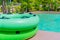 Green swim ring for water park slide on water park pool side