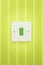 Green Switch on a white socket