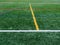 Green synthetic grass sports field with colorful lines