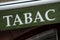 green tabacco store front with french text tabac, the