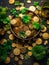 Green table with various coins and gold items placed on it. There are several pots of gold, some filled to brim while