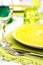 Green tableware and cutlery and white tablecloth set at an outdo