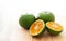 Green tangerines on a wooden background