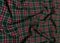Green tartan woolen school uniform fabric material. Scottish classic seamless flannel cloth. Traditional wave pattern