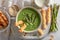 Green and tasty creamy asparagus soup served with grissini